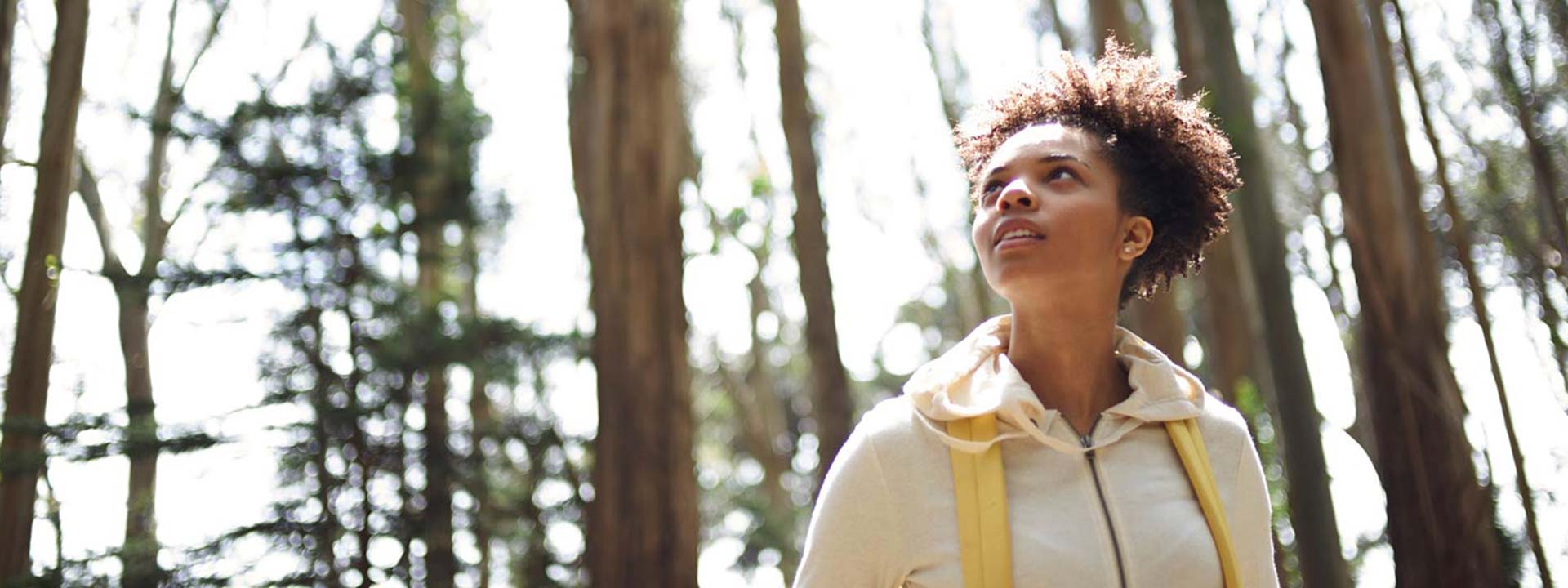 woman hiking through the woods