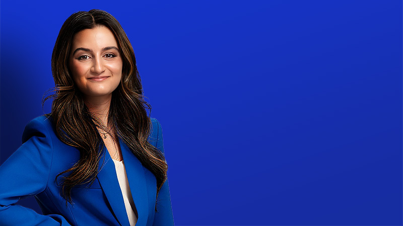 Persheng smiling in front of blue background