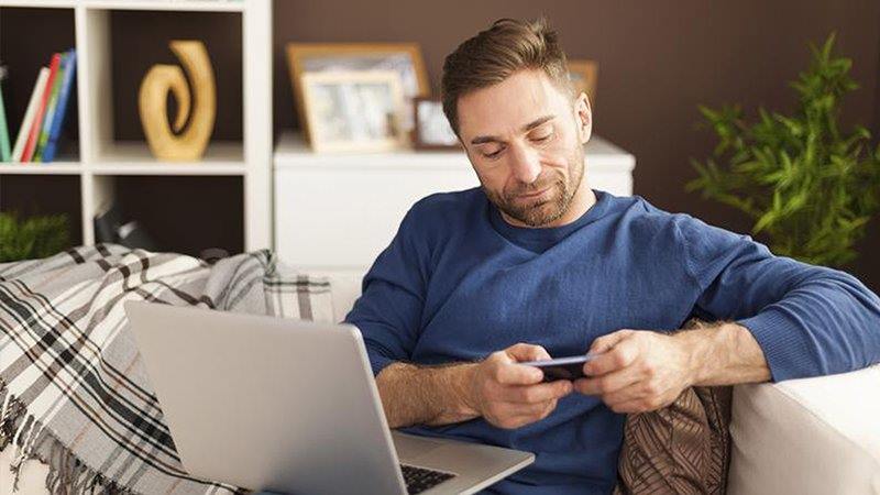 man on phone and laptop