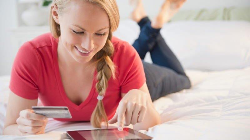 woman using card and tablet